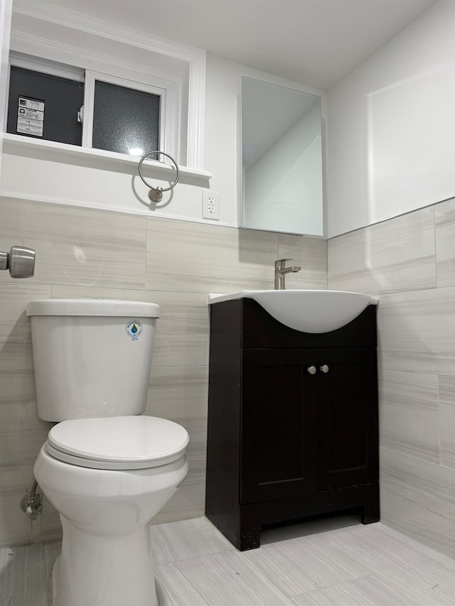 4223 Boyd Ave, Bronx, NY 10466 - bathroom featuring tile walls, vanity, and a wainscoted wall