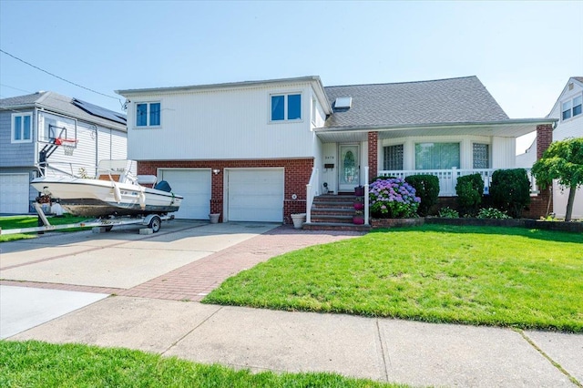 3478 Woodward St, Oceanside, NY 11572 - tri-level home featuring brick siding, a front lawn, driveway, a porch, and an attached garage