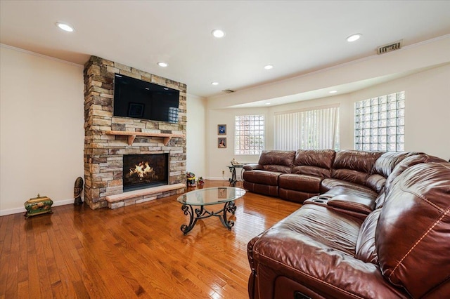 3478 Woodward St, Oceanside, NY 11572 - living area featuring ornamental molding, wood finished floors, a stone fireplace, and recessed lighting