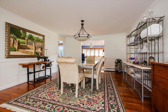 3478 Woodward St, Oceanside, NY 11572 - dining area with wood finished floors, a baseboard heating unit, and crown molding
