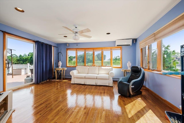 3478 Woodward St, Oceanside, NY 11572 - living room featuring a wall unit AC, a ceiling fan, wood finished floors, recessed lighting, and a baseboard radiator