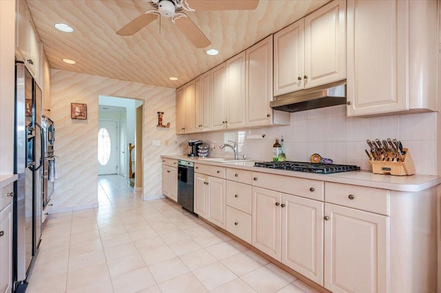 3478 Woodward St, Oceanside, NY 11572 - kitchen with under cabinet range hood, stainless steel gas cooktop, light countertops, a ceiling fan, and dishwasher