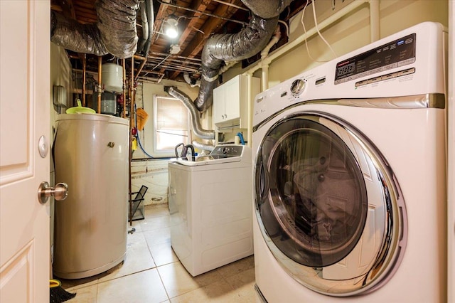 3478 Woodward St, Oceanside, NY 11572 - laundry room with water heater, independent washer and dryer, cabinet space, and light tile patterned floors