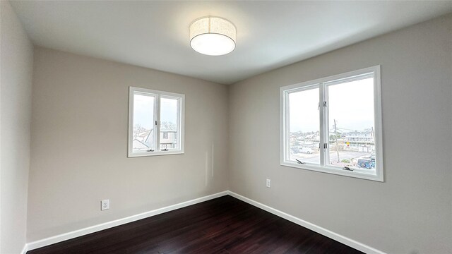 102 Surf Rd, Lindenhurst, NY 11757 - unfurnished room featuring dark wood-style flooring and baseboards
