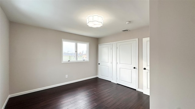 102 Surf Rd, Lindenhurst, NY 11757 - unfurnished bedroom with dark wood-type flooring and a closet