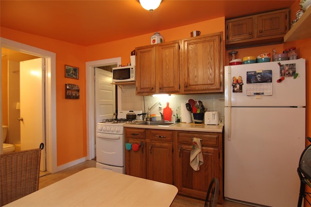 3155 Lexington Ave Unit 18Ab, Mohegan Lake, NY 10567 - kitchen with white appliances, light countertops, decorative backsplash, and brown cabinets