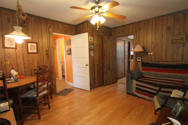3155 Lexington Ave Unit 18Ab, Mohegan Lake, NY 10567 - living room featuring a ceiling fan, wood walls, light wood-style floors, and crown molding