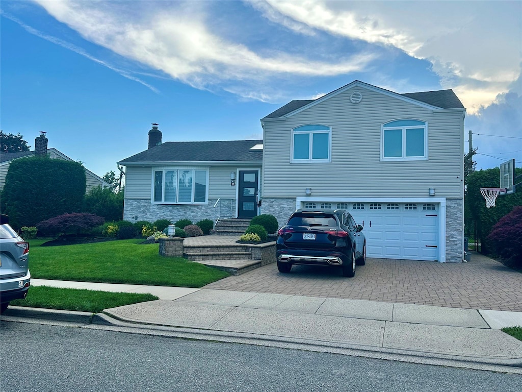 17 Keswick Ln, Plainview, NY 11803 - split level home featuring stone siding, decorative driveway, and an attached garage
