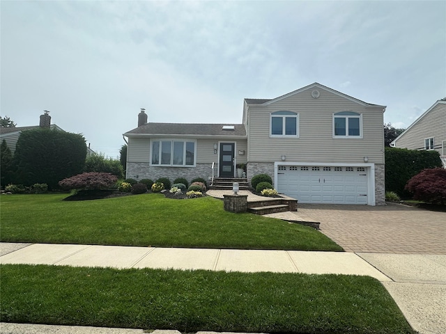 17 Keswick Ln, Plainview, NY 11803 - tri-level home with stone siding, decorative driveway, a garage, a chimney, and a front yard