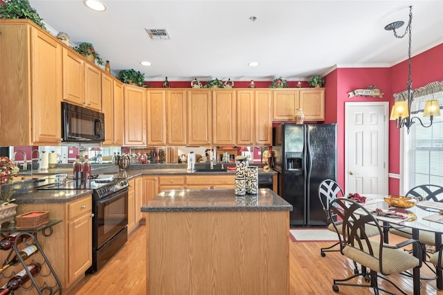 17 Meadow Pond Cir, Miller Place, NY 11764 - kitchen with black appliances, a center island, light wood-style floors, hanging light fixtures, and dark stone countertops