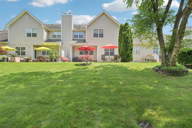17 Meadow Pond Cir, Miller Place, NY 11764 - back of property featuring a chimney, a yard, and a patio area