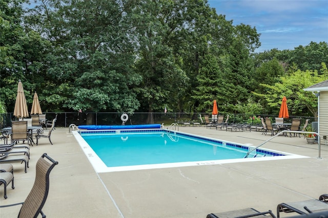 17 Meadow Pond Cir, Miller Place, NY 11764 - community pool with a patio, outdoor dining area, and view of scattered trees