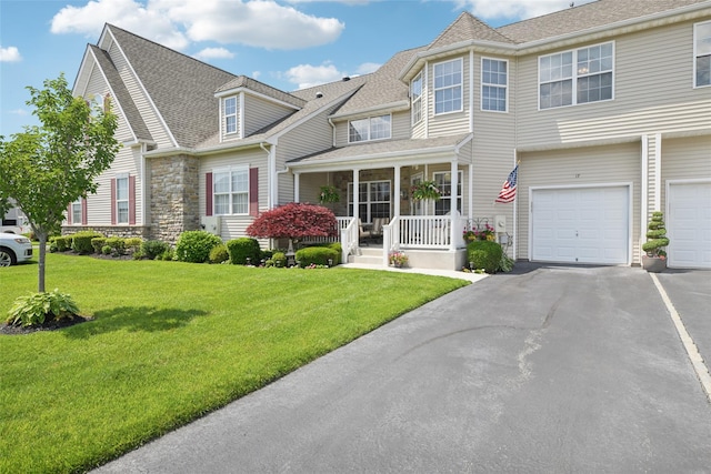 17 Meadow Pond Cir, Miller Place, NY 11764 - view of front of house featuring covered porch, driveway, a front yard, a garage, and roof with shingles