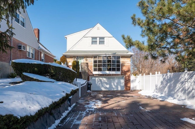 19611 Pompeii Ave, Hollis, NY 11423 - view of front of home with an attached garage, brick siding, and decorative driveway