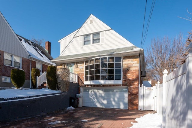 19611 Pompeii Ave, Hollis, NY 11423 - view of front of home with an attached garage, brick siding, and decorative driveway