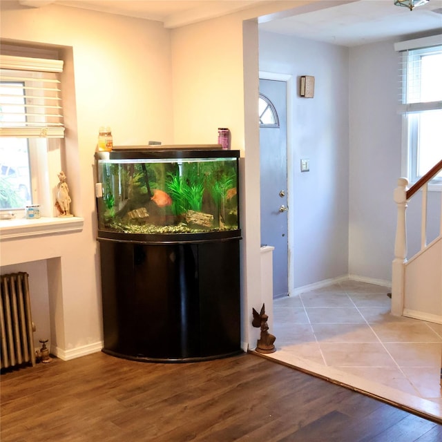 24 Pine St, Oceanside, NY 11572 - bar area with radiator, wood finished floors, and stairs