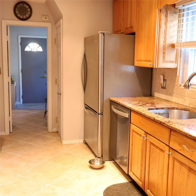 24 Pine St, Oceanside, NY 11572 - kitchen with dishwasher, light stone countertops, decorative backsplash, light tile patterned flooring, and brown cabinetry