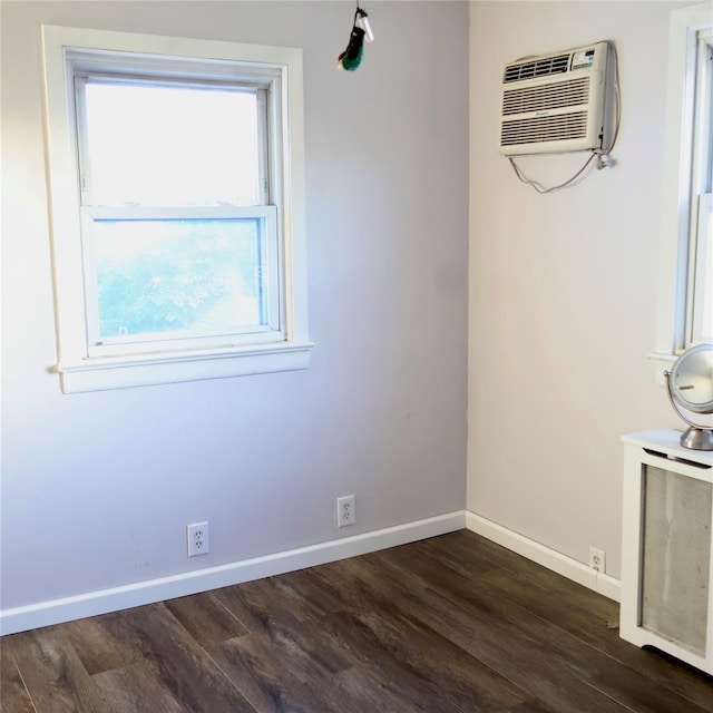 24 Pine St, Oceanside, NY 11572 - spare room featuring a wall mounted air conditioner and dark wood-style flooring