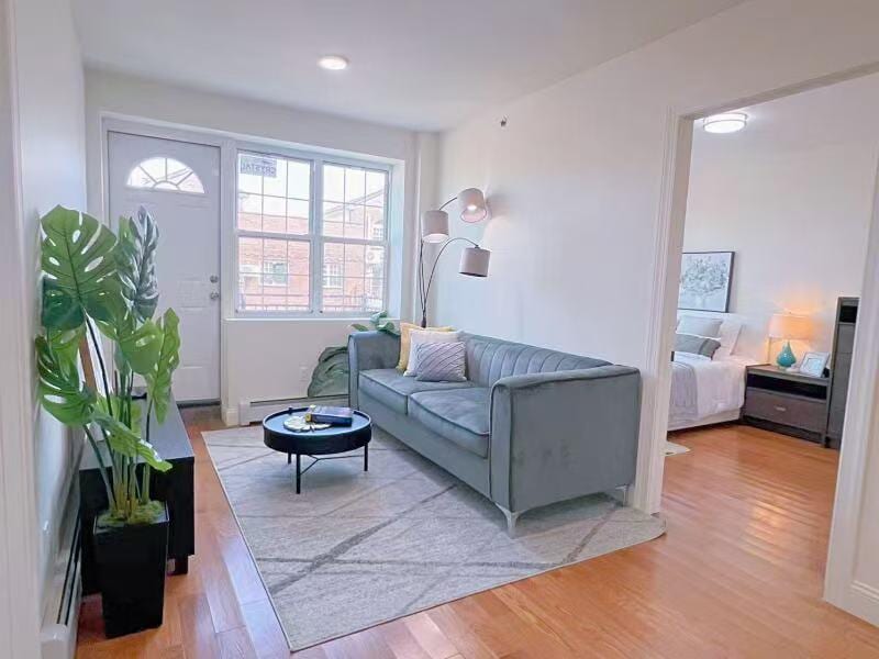 141-15 Cherry Ave Unit 2E, Flushing, NY 11355 - living area featuring wood finished floors and a baseboard heating unit
