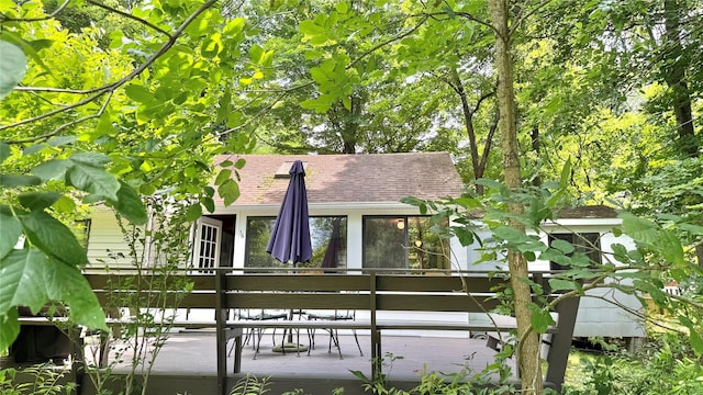 3300 Baker St Unit 16, Mohegan Lake, NY 10547 - back of property featuring a wooden deck, roof with shingles, and a sunroom