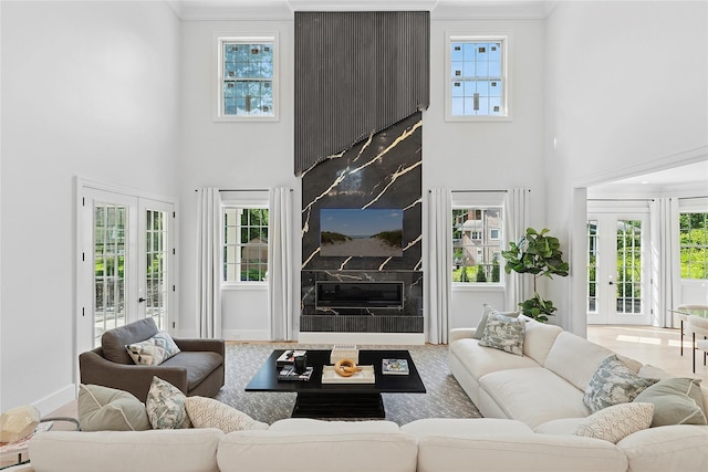 17 Chelsea Pl, Dix Hills, NY 11746 - living area featuring a premium fireplace, a high ceiling, french doors, plenty of natural light, and crown molding