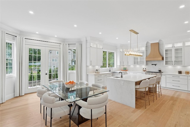 17 Chelsea Pl, Dix Hills, NY 11746 - dining room featuring light wood-type flooring, recessed lighting, crown molding, and french doors
