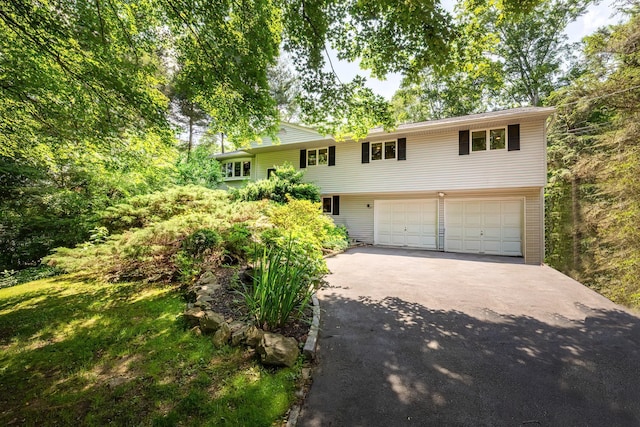 29 Meadow Ln, Chappaqua, NY 10514 - view of front facade featuring asphalt driveway and a garage