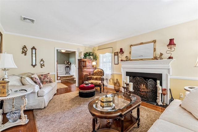 42 Roxen Rd, Rockville Centre, NY 11570 - living area with wood finished floors, a fireplace with flush hearth, and crown molding