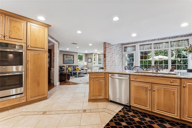 42 Roxen Rd, Rockville Centre, NY 11570 - kitchen with stainless steel appliances, light tile patterned flooring, recessed lighting, and light stone counters