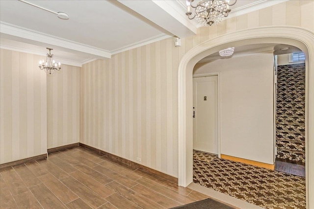 104 S Village Ave S Unit 1F, Rockville Centre, NY 11570 - spare room featuring a chandelier, arched walkways, wood finished floors, and crown molding