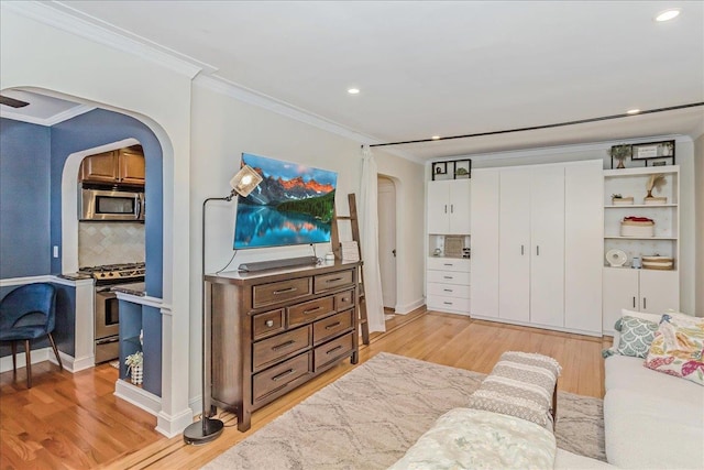 104 S Village Ave S Unit 1F, Rockville Centre, NY 11570 - living area featuring arched walkways, crown molding, light wood-type flooring, and recessed lighting