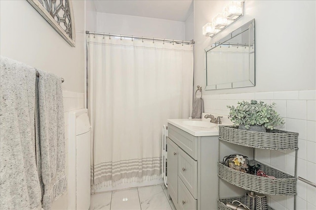 104 S Village Ave S Unit 1F, Rockville Centre, NY 11570 - bathroom featuring vanity, marble finish floors, a wainscoted wall, washer / clothes dryer, and curtained shower