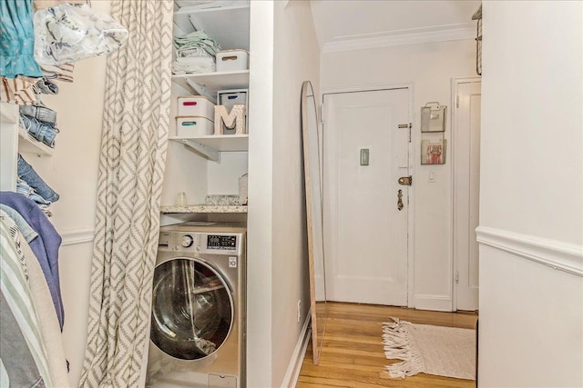 104 S Village Ave S Unit 1F, Rockville Centre, NY 11570 - laundry area featuring washer / clothes dryer, ornamental molding, and light wood finished floors