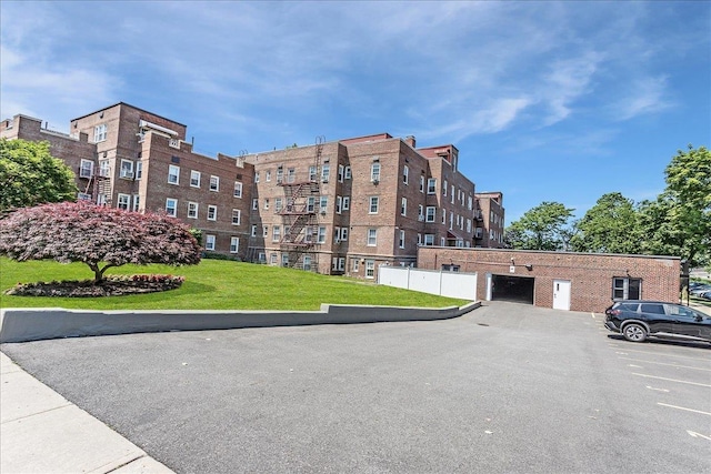 104 S Village Ave S Unit 1F, Rockville Centre, NY 11570 - view of apartment building / complex featuring uncovered parking