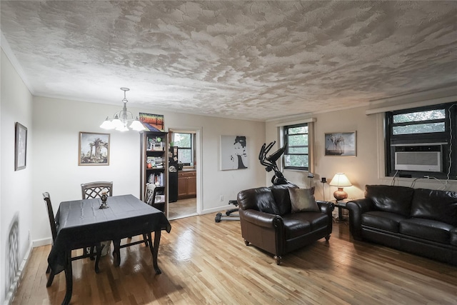 160-54 Willets Point Blvd Unit 4-206, Whitestone, NY 11357 - living room featuring cooling unit, a chandelier, light wood-style floors, and a textured ceiling