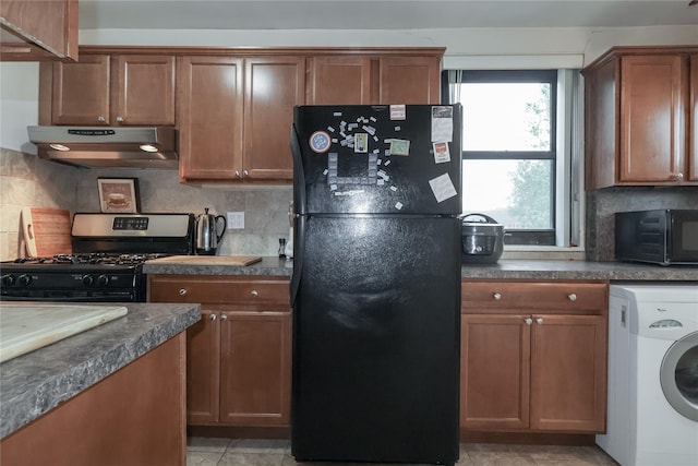 160-54 Willets Point Blvd Unit 4-206, Whitestone, NY 11357 - kitchen with freestanding refrigerator, washer / dryer, gas stove, under cabinet range hood, and dark countertops