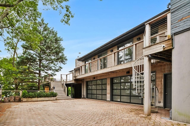 55C Shore Rd, Shelter Island, NY 11964 - view of front of home featuring stairway, decorative driveway, and a garage