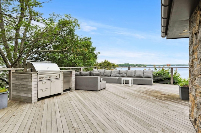 55C Shore Rd, Shelter Island, NY 11964 - wooden deck with an outdoor hangout area, exterior kitchen, and a water view