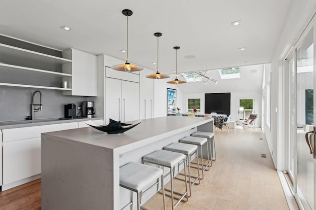 55C Shore Rd, Shelter Island, NY 11964 - kitchen with a skylight, white cabinetry, modern cabinets, open shelves, and recessed lighting