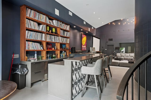 55C Shore Rd, Shelter Island, NY 11964 - bar area featuring high vaulted ceiling and concrete floors
