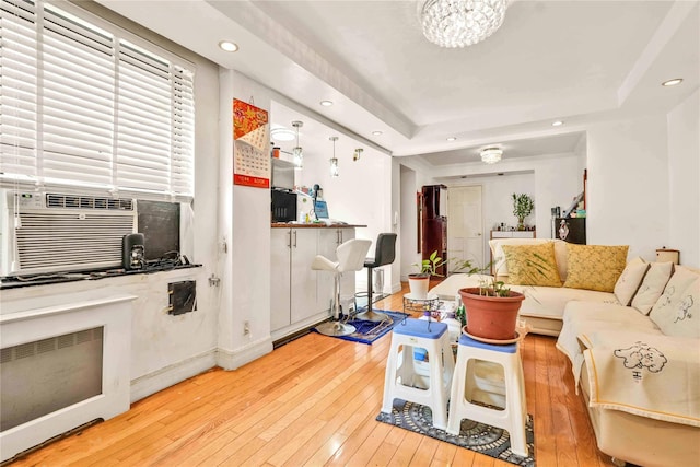 141-15 28th Ave Unit 1G, Flushing, NY 11354 - living area featuring light wood-type flooring, recessed lighting, a tray ceiling, cooling unit, and a chandelier