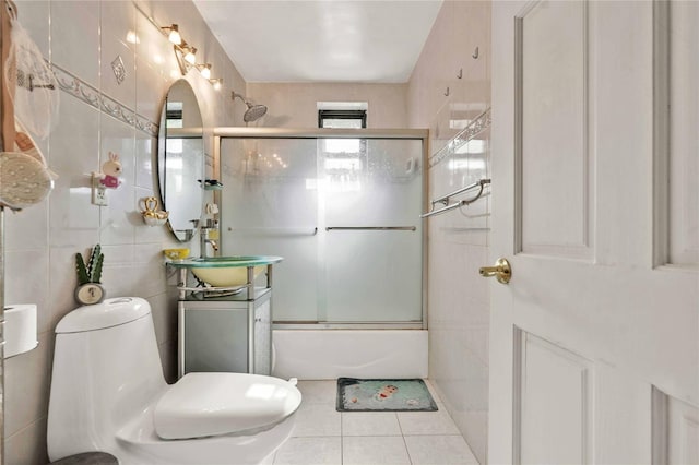 141-15 28th Ave Unit 1G, Flushing, NY 11354 - bathroom featuring tile walls, vanity, bath / shower combo with glass door, and tile patterned flooring