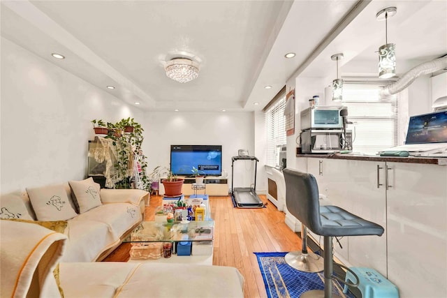 141-15 28th Ave Unit 1G, Flushing, NY 11354 - living room featuring a tray ceiling, light wood-style flooring, and recessed lighting