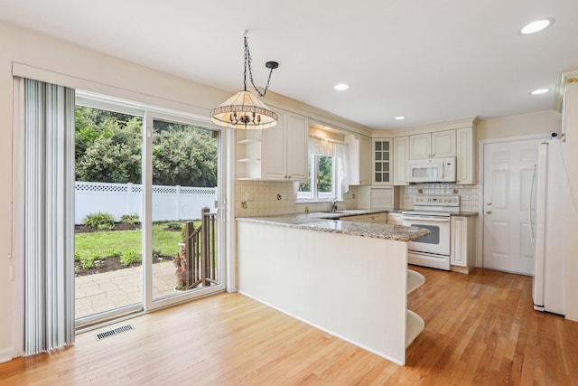 37 Baxter Rd, Pawling, NY 12564 - kitchen featuring white appliances, a peninsula, decorative backsplash, light wood-style floors, and recessed lighting