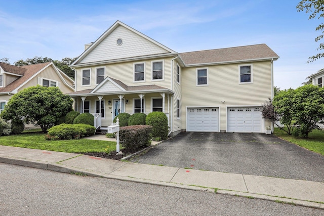 37 Baxter Rd, Pawling, NY 12564 - victorian house featuring asphalt driveway, an attached garage, covered porch, and a chimney