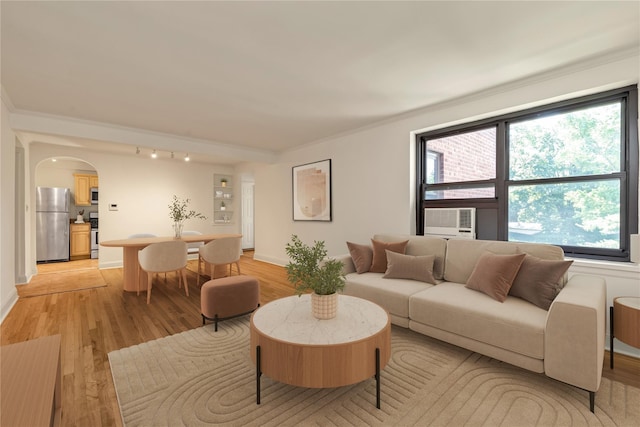 212-04 75th Ave Unit 4J, Bayside, NY 11364 - living area with arched walkways, light wood-style floors, healthy amount of natural light, cooling unit, and ornamental molding