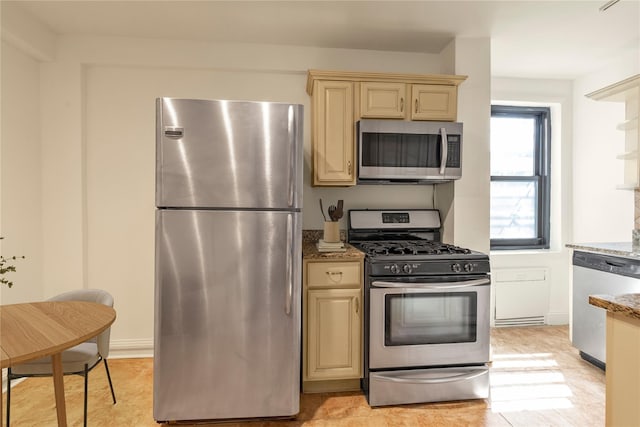 212-04 75th Ave Unit 4J, Bayside, NY 11364 - kitchen with stainless steel appliances, light stone counters, and cream cabinets