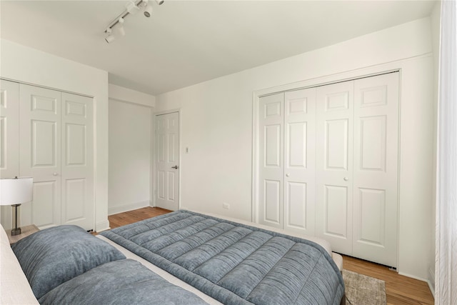 212-04 75th Ave Unit 4J, Bayside, NY 11364 - bedroom with light wood finished floors and rail lighting