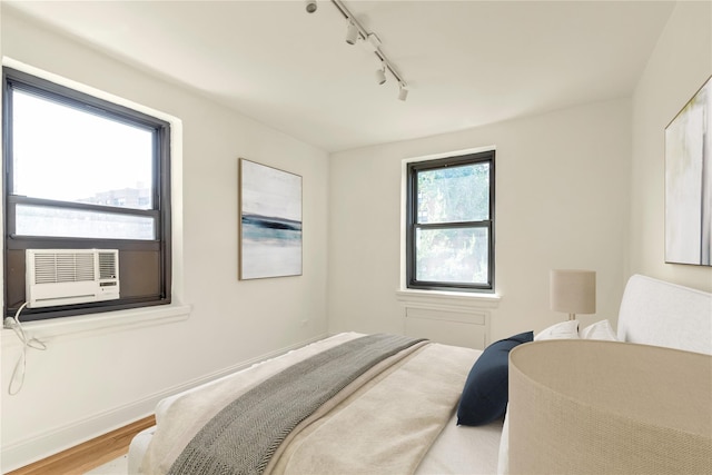 212-04 75th Ave Unit 4J, Bayside, NY 11364 - bedroom featuring rail lighting and wood finished floors