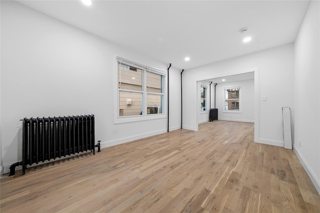 163 Grant Ave, Mineola, NY 11501 - unfurnished living room with radiator, light wood-style floors, and recessed lighting